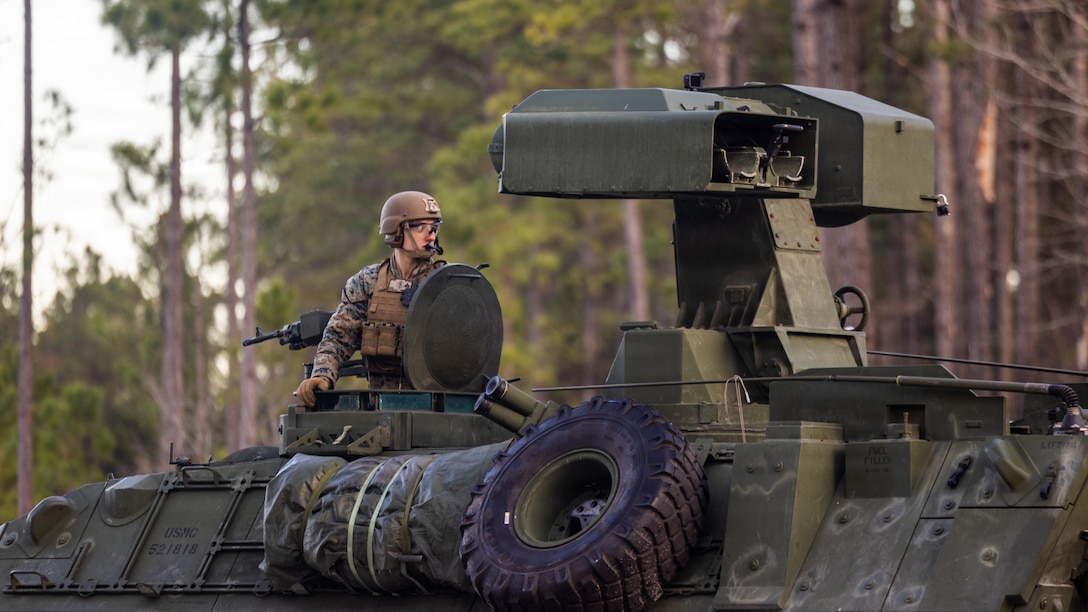 U.S. Marine Corps Cpl. Philip Richman, an anti-tank missile gunner with 2nd Light Armored Reconnaissance Battalion, 2nd Marine Division, awaits permission to fire during a Tube-launched, Optically-tracked, Wire-guided missile range on Marine Corps Base Camp Lejeune, North Carolina, Dec. 11, 2025. The range integrates the long range, standoff capabilities of the TOW missile with the battlespace awareness advantages of LAR scout teams and the direct fire capabilities of the Light Armored Vehicle 25’s 30mm Bushmaster chain gun. (U.S. Marine Corps photo by Lance Cpl. Brian Bolin Jr.)
