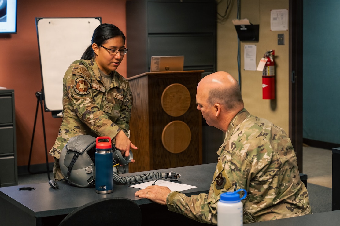 U.S. Air Force Staff Sgt. Natalie Saucedo, left, 2nd Operations Support Squadron Aircrew Flight Equipment specialist, briefs Gen. S. L. Davis, commander of Air Force Global Strike Command, on the proper use of B-52 aircrew flight equipment at Barksdale Air Force Base, Louisiana, Feb. 2, 2026. Davis visited the 2 OSS AFE flight as part of his immersion with the 2nd Bomb Wing to see firsthand how AFE Airmen inspect, maintain, and manage life-saving equipment for Team Barksdale air crew members. (U.S. Air Force photo by Senior Airman Seth Watson)