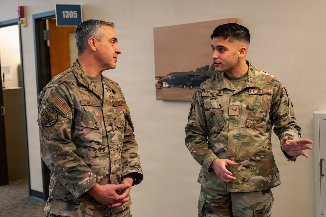 U.S. Air Force Chief Master Sgt. Shawn M. Aiello, left, Air Force Global Strike Command command chief, talks with Senior Airman Alejandro Puente San, 2nd Force Support Squadron personnelist, during a tour of the military personnel flight at Barksdale Air Force Base, Louisiana, Feb. 3, 2026. Aiello is the command’s senior enlisted leader and principal advisor to the commander on issues impacting Airmen's welfare, visits like this enable him to get a touch point with the ground level force and allow Airmen to gain strategic insight on their role in AFGSC. (U.S. Air Force photo by Senior Airman Seth Watson)