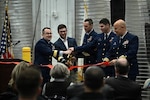 Coast Guard Rear Adm. Russell E. Dash (left), commander of the Great Lakes District, joins the official party for the ribbon-cutting ceremony for the newly built Station and Aids to Navigation Team Buffalo building on Jan. 12, 2026. U.S. Coast Guard photo by Petty Officer 2nd Class Omar Faba.