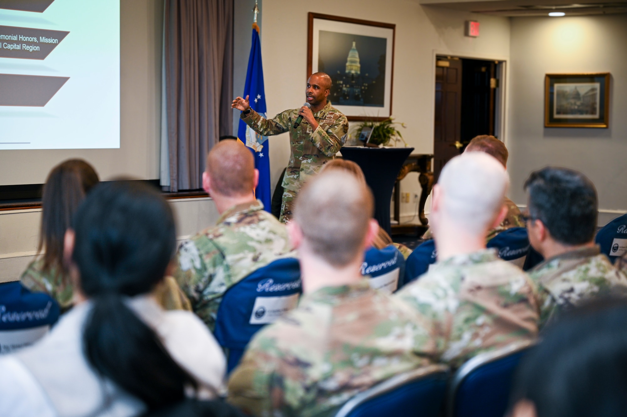 U.S. Air Force Chief Master Sgt. Anthony Thompson Jr., senior enlisted leader for Joint Base Anacostia-Bolling and 11th Wing command chief, discusses readiness during a wing all-call at JBAB, Washington, D.C., Jan. 13, 2026. He used a coin to explain that personal readiness and professional readiness go hand in hand with each other. (U.S. Air Force photo by Airman 1st Class Shanel Toussaint)