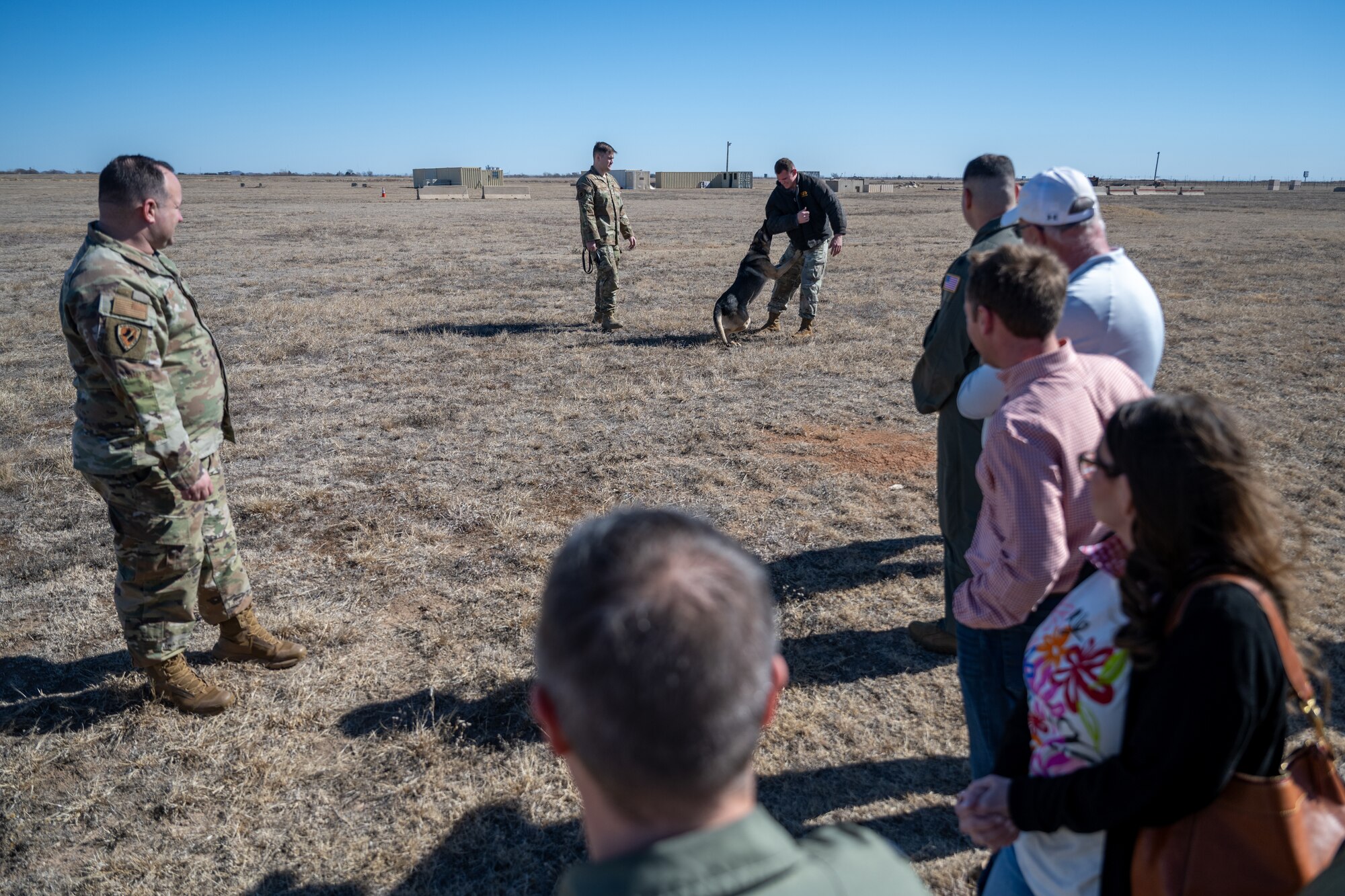 U.S. Air Force Airmen assigned to the 97th Security Forces Squadron demonstrate the bite-and-chase capabilities of a military working dog at Altus Air Force Base, Oklahoma, Feb. 6, 2026. The demonstration highlighted how military working dog teams support installation security through controlled apprehension and obedience training. (U.S. Air Force photo by Airman 1st Class Nathan Langston)