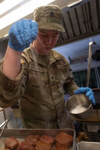 Spc. Brayden Buffalohead, a member of the 903rd Quartermaster Company, seasons steaks during the third annual Oklahoma Army National Guard Culinary Excellence Competition, in Norman, Oklahoma, Feb. 8, 2026. Buffalohead is one of the five cooks on a team representing the 903rd who took first place in the competition - the third time in a row a team representing the 903rd has placed first in the competition designed to recognize outstanding OKARNG cooks. (Oklahoma National Guard photo by Staff Sgt. Anthony Jones)