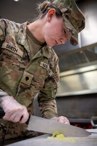 Spc. Kaslyn Smith, a member of Hotel Company, 700th Brigade Support Battalion, chops vegetables during the third annual Oklahoma Army National Guard Culinary Excellence Competition in Norman, Oklahoma, Feb. 8, 2026. This year’s OKARNG CEC hosted five teams from the 45th Infantry Brigade Combat Team and 90th Troop Command competing to be named the best team in the state. The competition is designed to recognize outstanding OKARNG cooks. (Oklahoma National Guard photo by Staff Sgt. Anthony Jones)