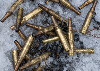 Shell casings from blank rounds lie in the snow during a force-on-force exercise in Garrison, North Dakota, Feb. 6, 2026. Blank rounds were used by Airmen during the exercise to safely simulate armed encounters. (U.S. Air Force photo by Senior Airman Kyle Wilson)