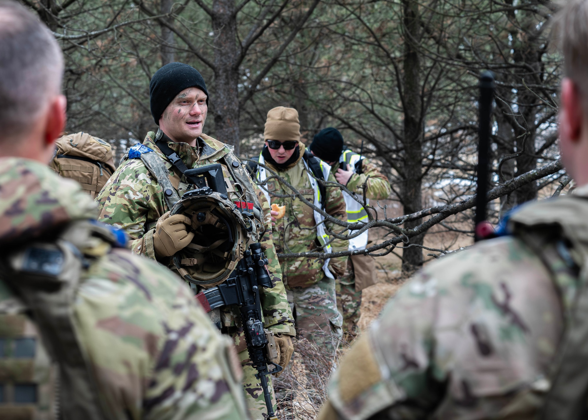 U.S. Air Force 1st Lt. Cole Lautt (center left), 91st Missile Security Operations Squadron (91MSOS) convoy response force flight commander, discusses tactics with his team during a force-on-force exercise at Garrison, North Dakota, Feb. 6, 2026. Lautt emphasized the importance of clear communication and teamwork for mission success. (U.S. Air Force photo by Senior Airman Kyle Wilson)