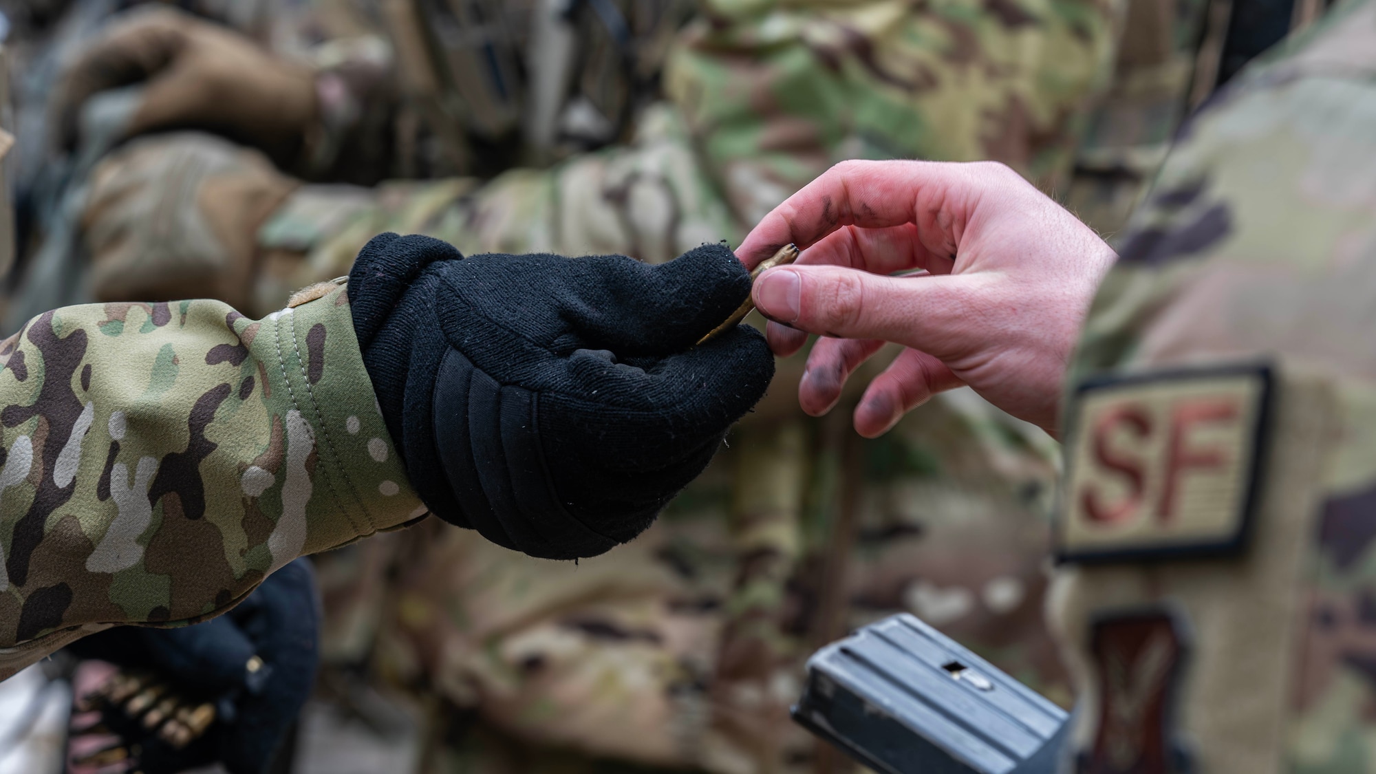 U.S. Airmen assigned to the 91st Missile Security Operations Squadron load magazines with blank rounds during a force-on-force exercise in Garrison, North Dakota, Feb. 6, 2026. Airmen fired blank rounds during the exercise to safely simulate armed encounters. (U.S. Air Force photo by Senior Airman Kyle Wilson)