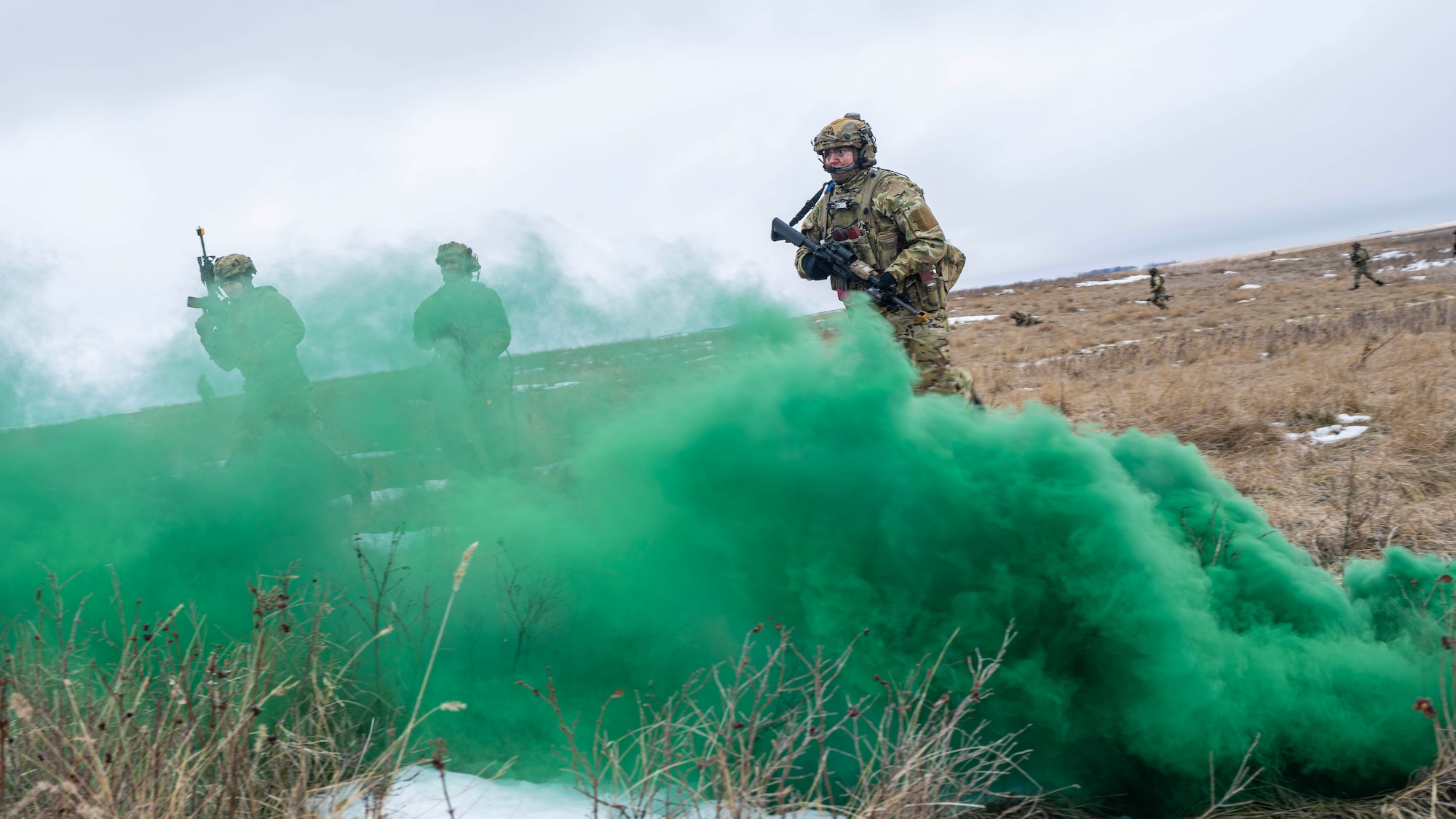 U.S. Airmen assigned to the 91st Missile Security Operations Squadron assault a simulated opposing force during a force-on-force exercise in Garrison, North Dakota, Feb. 6, 2026. The Airmen used a smoke grenade to conceal their movement and positioning. (U.S. Air Force photo by Senior Airman Kyle Wilson)