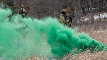 U.S. Airmen assigned to the 91st Missile Security Operations Squadron assault a simulated opposing force during a force-on-force exercise in Garrison, North Dakota, Feb. 6, 2026. The Airmen used a smoke grenade to conceal their movement and positioning. (U.S. Air Force photo by Senior Airman Kyle Wilson)