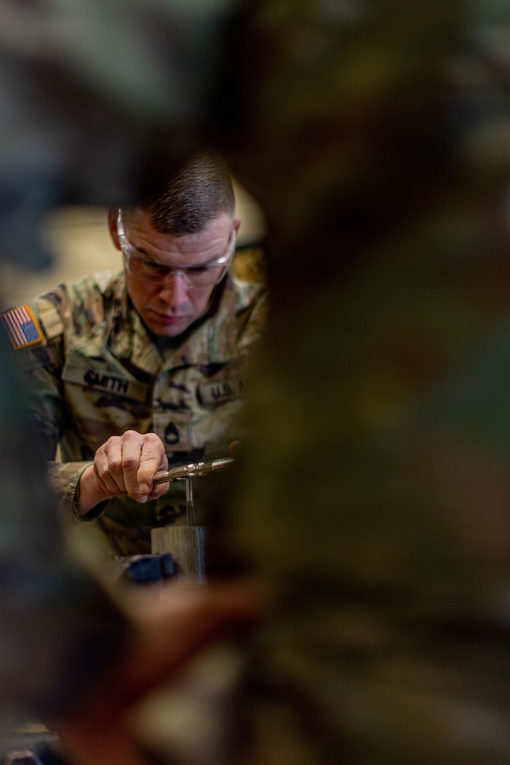 Sgt. 1st Class Daniel Smith, 120th Forward Support Company, 45th Field Artillery Brigade, Oklahoma Army National Guard, uses a tap and die set during the OKARNG’s 2026 Best Mechanic competition at the Combined Support Maintenance Shop in Norman, Oklahoma, Feb. 7, 2026. Guardsmen from across the state took part in a series of stations designed to test their skills in diagnostics, technical proficiency, including electrical circuits, measuring and inspection, and the use of the Army’s maintenance management system. (Oklahoma National Guard photo by Sgt. Haden Tolbert)