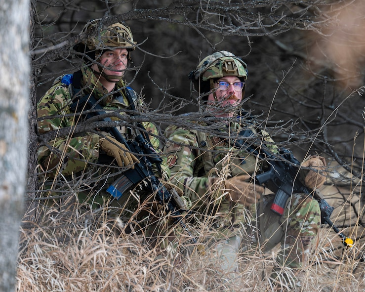 U.S. Air Force 1st Lt. Cole Lautt (left), 91st Missile Security Operations Squadron (91MSOS) convoy response force flight commander, and U.S. Air Force Master Sgt. Brandon Priddy, 91MSOS convoy response force flight chief, monitor their surroundings during a force-on-force exercise in Garrison, North Dakota, Feb. 6, 2026. Lautt and his team identified and engaged simulated opposing forces as part of the exercise. (U.S. Air Force photo by Senior Airman Kyle Wilson)