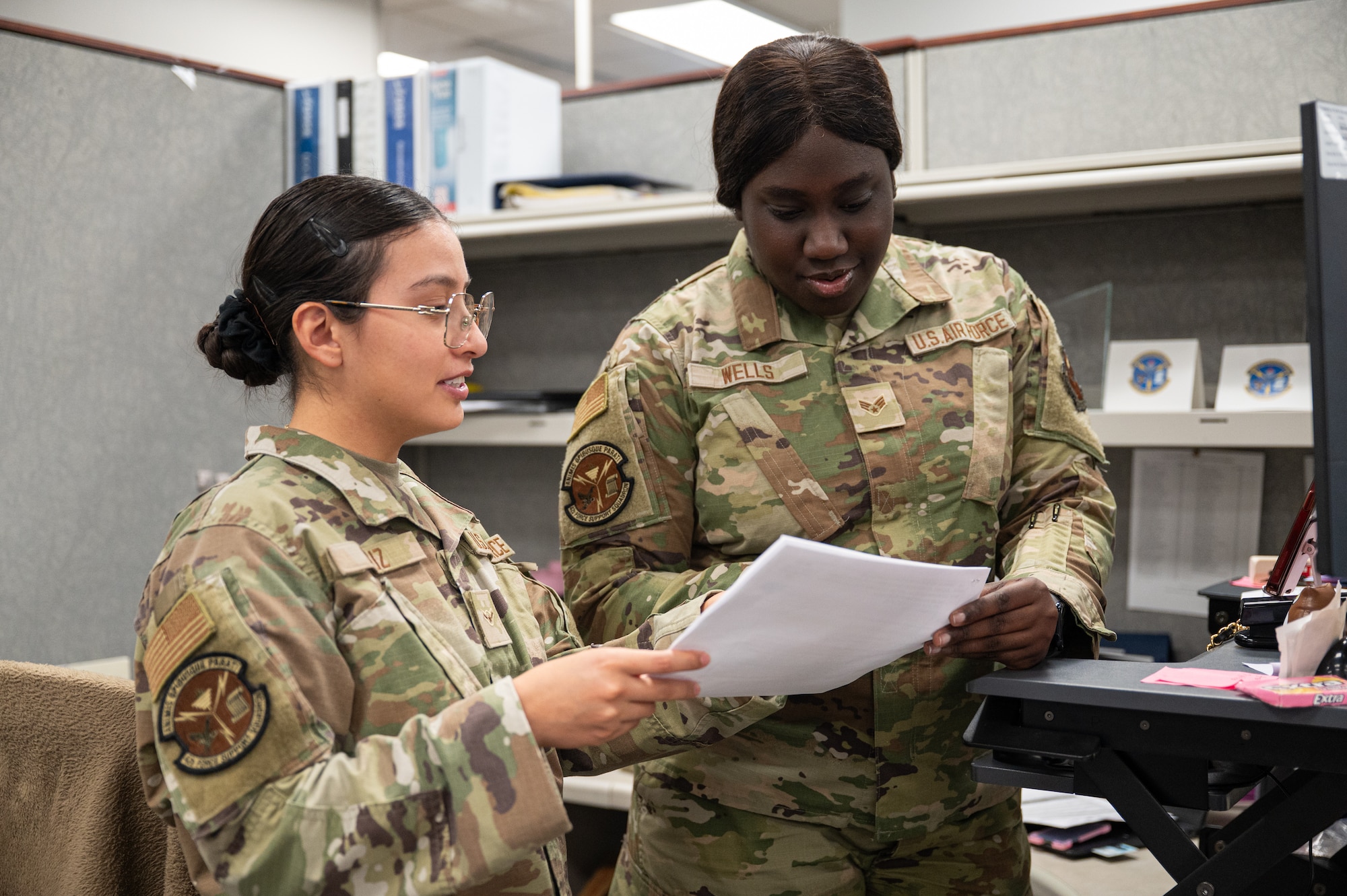U.S. Air Force Airman Natalia Cruz and Senior Airman Mya Wells, career development technicians, both assigned to the 42d Force Support Squadron Military Personnel Flight, address inquiries at Maxwell Air Force Base, Alabama, Feb. 9, 2026.