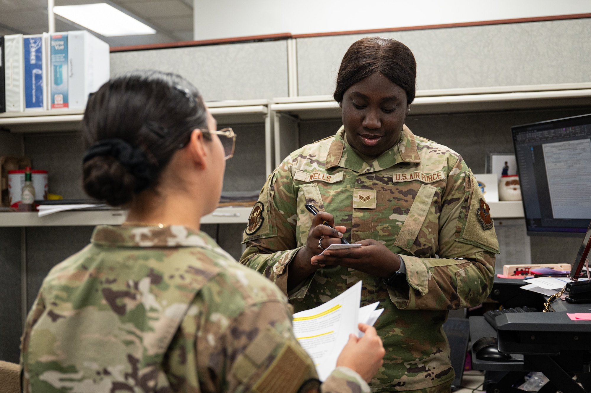 U.S. Air Force Senior Airman Mya Wells, with the 42d Force Support Squadron Military Personnel Flight career development technician, assists Airman Natalia Cruz, also a career development technician, with her questions at Maxwell Air Force Base, Alabama, Feb. 09, 2026.