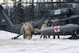 U.S. Army Soldiers assigned to 2nd Infantry Brigade Combat Team (Airborne),11th Airborne Division load a simulated casualty onto a UH-60 Black Hawk during a medical evacuation rehearsal at Yukon Training Center, Alaska, Feb. 10, 2026.