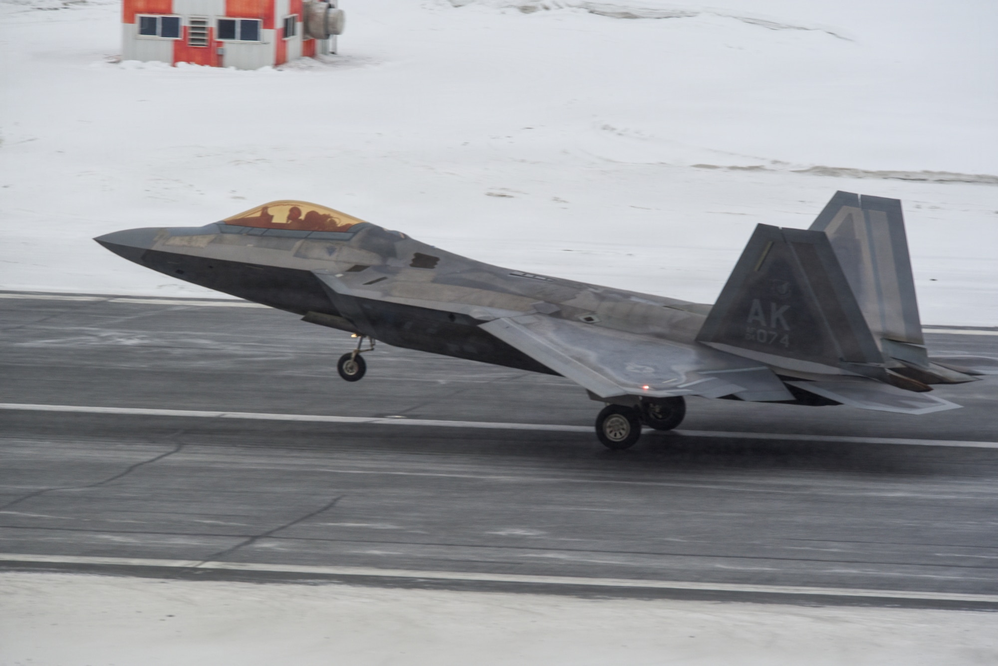 A U.S. Air Force F-22 Raptor assigned to the 3rd Wing takes flight during snowfall at Joint Base Elmendorf-Richardson, Alaska, Feb. 10, 2026. The F-22 Raptor is designed to project air dominance and cannot be matched by any known or projected fighter aircraft, providing power projection across the Indo-Pacific region. (U.S. Air Force photo by Nicholas Holland)