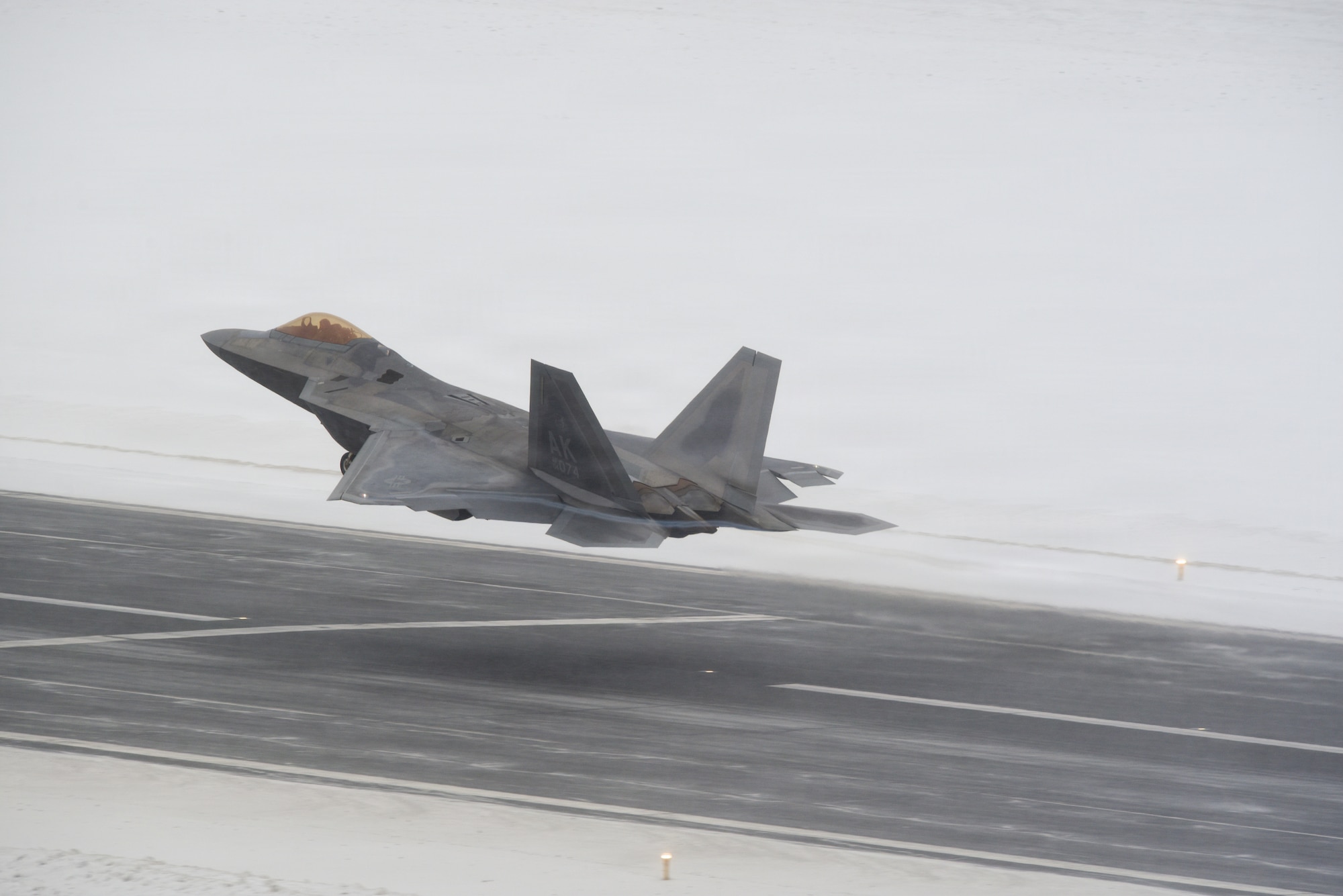 A U.S. Air Force F-22 Raptor assigned to 3rd Wing takes off during snow fall Joint Base Elmendorf-Richardson, Alaska, Feb. 10, 2026. The F-22 Raptor is designed to project air dominance and cannot be matched by any known or projected fighter aircraft, providing power projection across the Indo-Pacific region. (U.S. Air Force photo by Nicholas Holland)