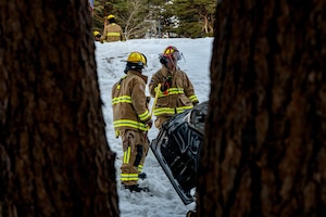 U.S. Air Force Airman 1st Class Josiah Smith, left, and Tadakatsu Kumagai, 35th Civil Engineer Squadron (CES) firefighters, survey a simulated car wreck during an inter-unit casualty and vehicle recovery exercise.