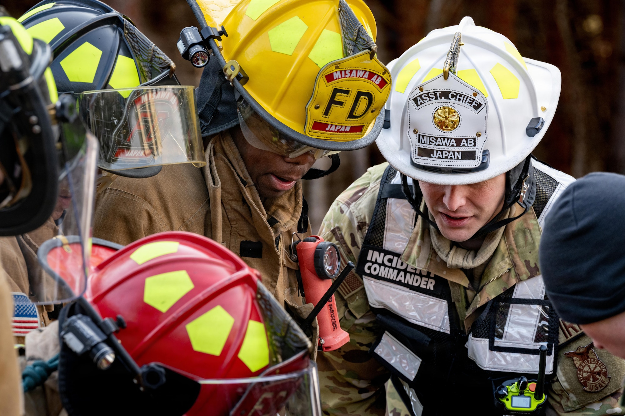 U.S. Airmen assigned to the 35th Civil Engineer Squadron (CES) and 35th Medical Group (MDG) surveys a simulated patient during an inter-unit casualty and vehicle recovery exercise.
