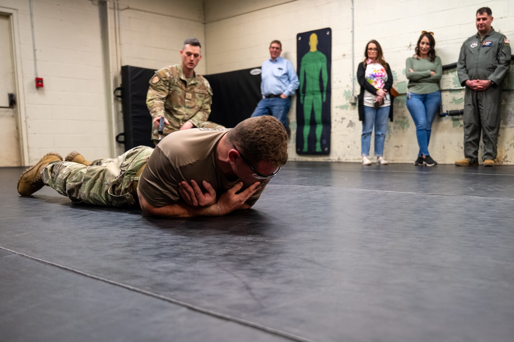 U.S. Air Force Senior Airman Donovan Saona, 97th Security Forces Squadron military working dog handler, is voluntarily tased to demonstrate the capability of a taser at Altus Air Force Base, Oklahoma, Feb. 6, 2026. The demonstration highlighted the effects of the device and reinforced safe employment procedures for personnel observing the immersion tour. (U.S. Air Force photo by Airman 1st Class Nathan Langston)