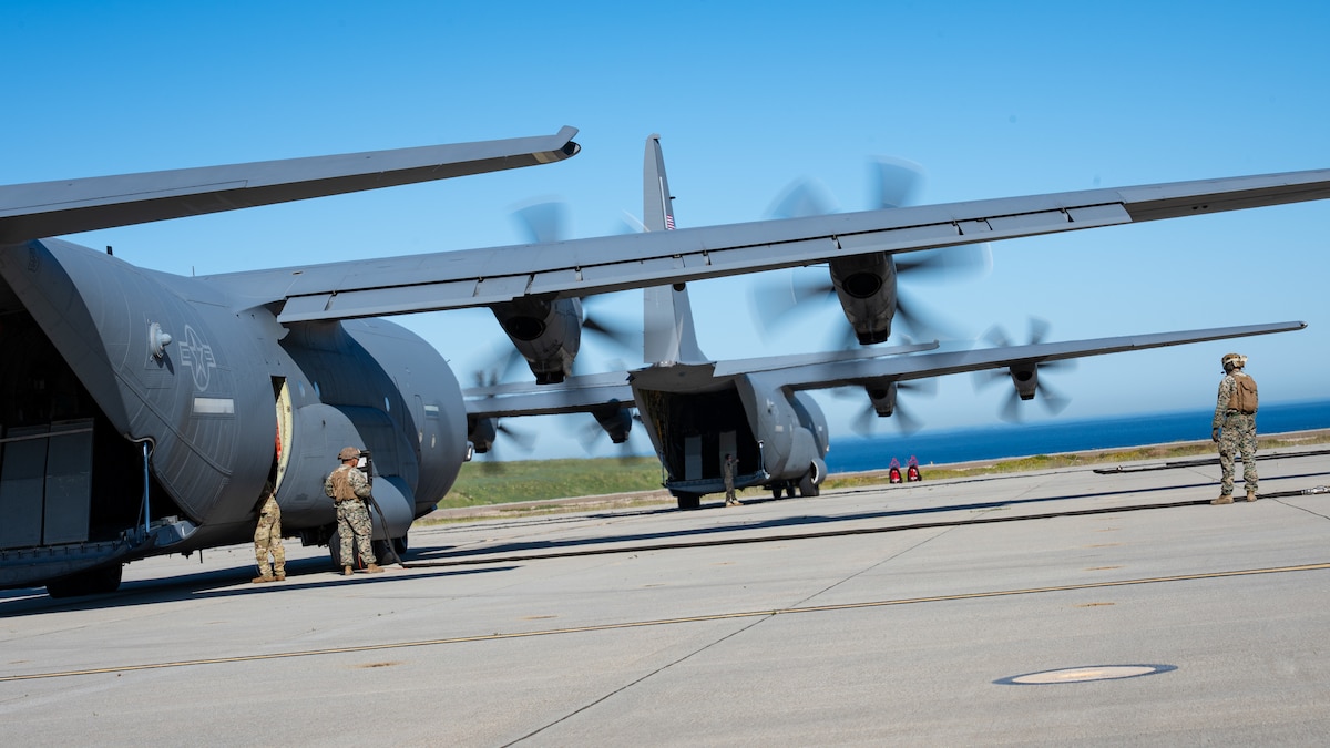 Two U.S. Air Force C-130J Super Hercules assigned to the 19th Airlift Wing and 317th Airlift Wing remain running while U.S. Marines assigned to Marine Wing Support Squadron 372 prepare fuel lines during Specialized Fueling Operations at Naval Landing Field, San Clemente Island, California, Feb. 4, 2026. The training validated repeatable joint fueling procedures in support of distributed operations during the Spring 2026 C-130 Weapon System Council led by the 317th AW. (U.S. Air Force photo by Senior Airman Jade M. Caldwell)
