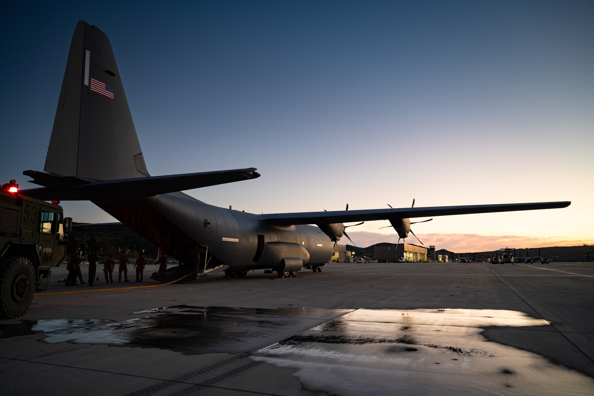 U.S. Marines assigned to the Marine Wing Support Squadron 372, Marine Aircraft Group 39, 3rd Marine Aircraft Wing, and U.S. Airmen assigned to the 317th Airlift Wing observe aircraft rescue and firefighting response training on a C-130J Super Hercules assigned to the 40th Airlift Squadron during the Spring 2026 C-130 Weapon System Council at Marine Corps Base Camp Pendleton, California, Feb. 4, 2026. This training exercise allowed the I Marine Expeditionary Force and 317th AW to understand how to safely execute missions and work together to respond to emergency scenarios. (U.S. Air Force photo by Senior Airman Jade M. Caldwell)