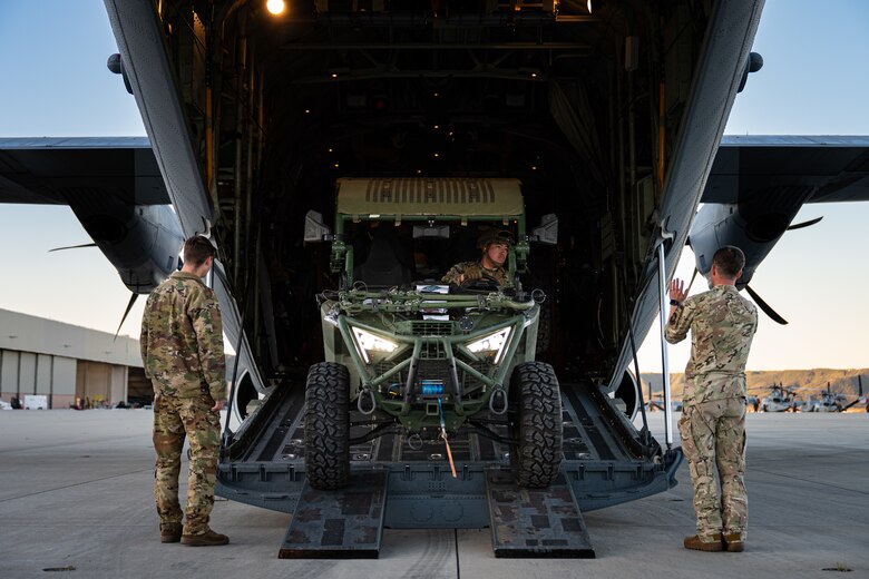 U.S. Marine Corps Lance Cpl. Talon Gardener, Marine Wing Support Squadron 372 expeditionary fuels technician, center, reverses an ultra-light tactical vehicle equipped with a Tactical Air Ground Refueling Systems onto a C-130J Super Hercules assigned to the 40th Airlift Squadron, as U.S. Air Force Senior Airman Matthew Monville and Master Sgt. Andy Cline, both 40th AS loadmasters, assist during the Spring 2026 C-130 Weapons System Council at Marine Corps Base Camp Pendleton, California, Feb. 4, 2026. During the WSC, Airmen conducted Specialized Fueling Operations training with I Marine Expeditionary Force. (U.S. Air Force photo by Senior Airman Jade M. Caldwell)