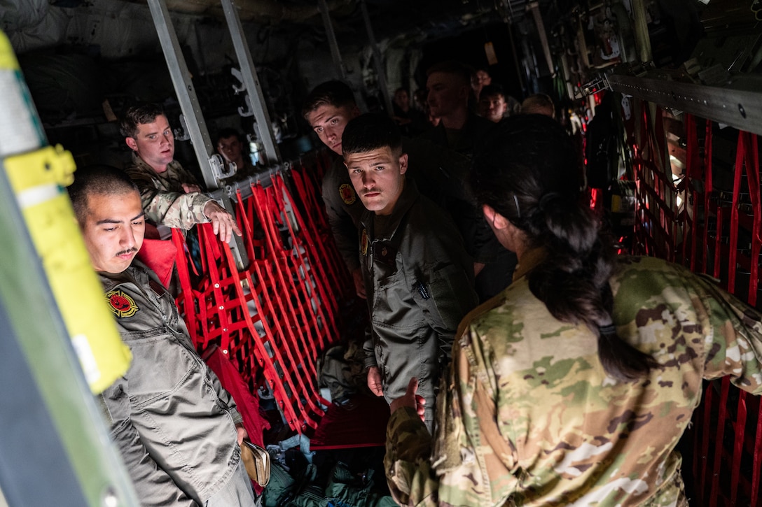U.S. Marines assigned to the Headquarters and Headquarters Squadron Aircraft Rescue and Firefighting Division receive a tour of a C-130J Super Hercules from U.S. Air Force Capt. Sydney Pasterski, 40th Airlift Squadron pilot, during the Spring 2026 C-130 Weapon System Council at Marine Corps Base Camp Pendleton, California, Feb. 3, 2026. Pasterski answered questions related to emergency equipment and response procedures on the aircraft, strengthening joint safety awareness and coordination between Airmen and I Marine Expeditionary Force personnel. (U.S. Air Force photo by Senior Airman Jade M. Caldwell)