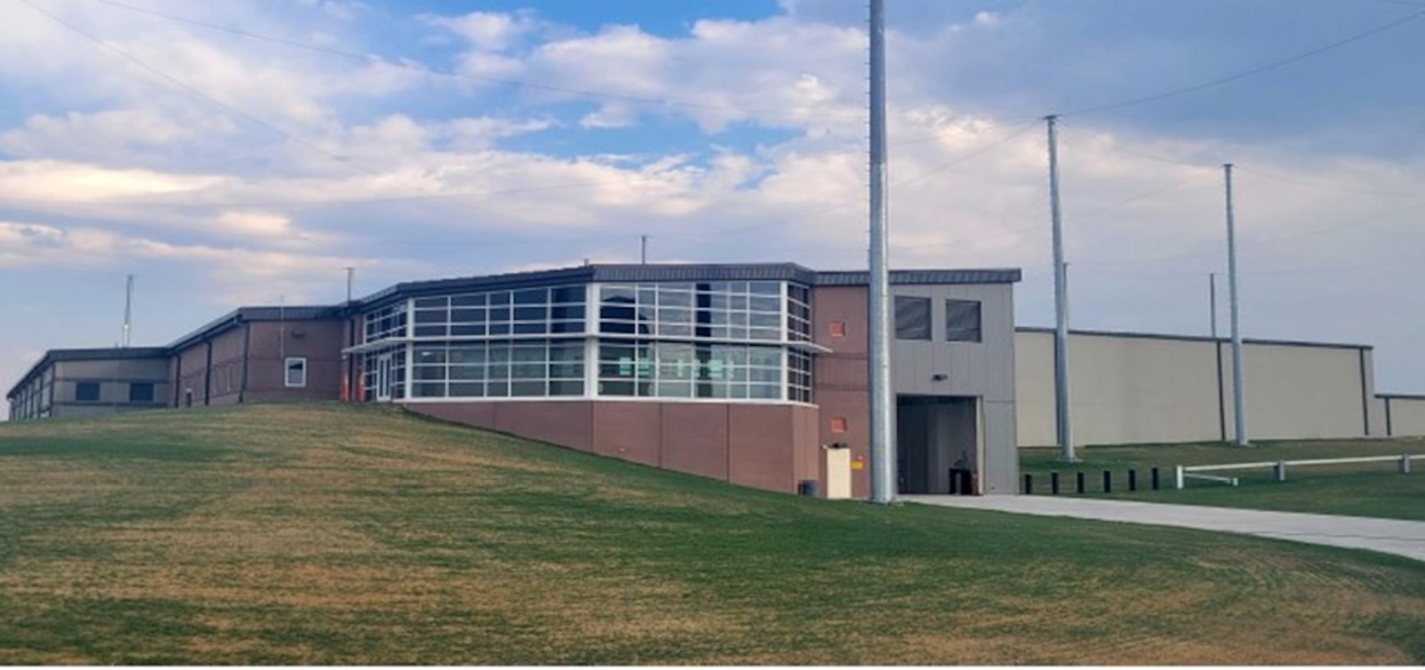 Large industrial building on grassy plane