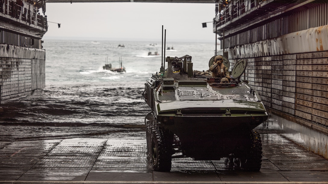 U.S. Marines with Alpha Company, 2nd Assault Amphibian Battalion, 2nd Marine Division operate an amphibious combat vehicle on the Whidbey Island-class dock landing ship USS Gunston Hall (LSD-44) during Naval Integration Training Package 2, off the coast of North Carolina, Dec. 5, 2025. NITP-2 is an amphibious, ship-to-shore, part of a larger training evolution certifying amphibious combat vehicle crewmen to safely and properly conduct combat operations with the ACV. (U.S. Marine Corps photo by Lance Cpl. Dominic Trujillo)