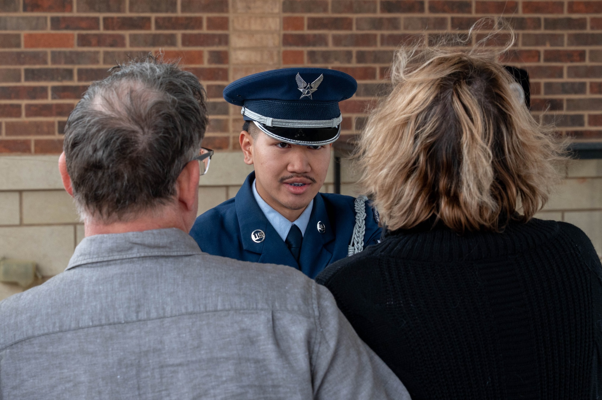 U.S. Air Force Airman 1st Class Nickey Phanhsopha, 7th Force Support Squadron ceremonial guardsman, presents the U.S. flag to the next-of-kin during a funeral service at the Texas State Veterans Cemetery in Abilene, Texas, Jan. 13, 2026. The presentation of the flag to the next-of-kin serves as a keepsake that symbolizes the service and dedication that military members give to their country. (U.S. Air Force photo by Airman William Neal)