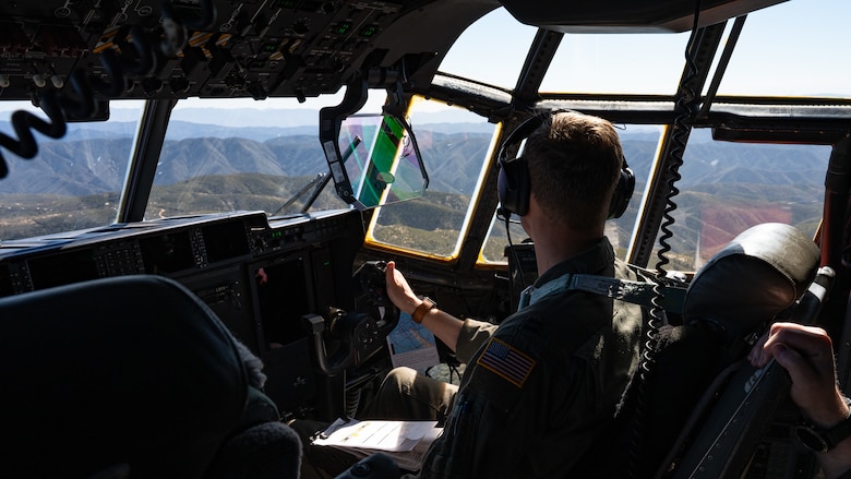 U.S. Air Force Capt. Reece Cooke, 40th Airlift Squadron pilot, observes terrain from a C-130J Super Hercules during low-level flight over the Peninsular Ranges, California, Feb. 4, 2026. The aircraft carried an ultra-light tactical vehicle and U.S. Marines assigned to Marine Wing Support Squadron 372, providing realistic joint training during the Spring 2026 C-130 Weapon System Council led by the 317th Airlift Wing. (U.S. Air Force photo by Senior Airman Jade M. Caldwell)