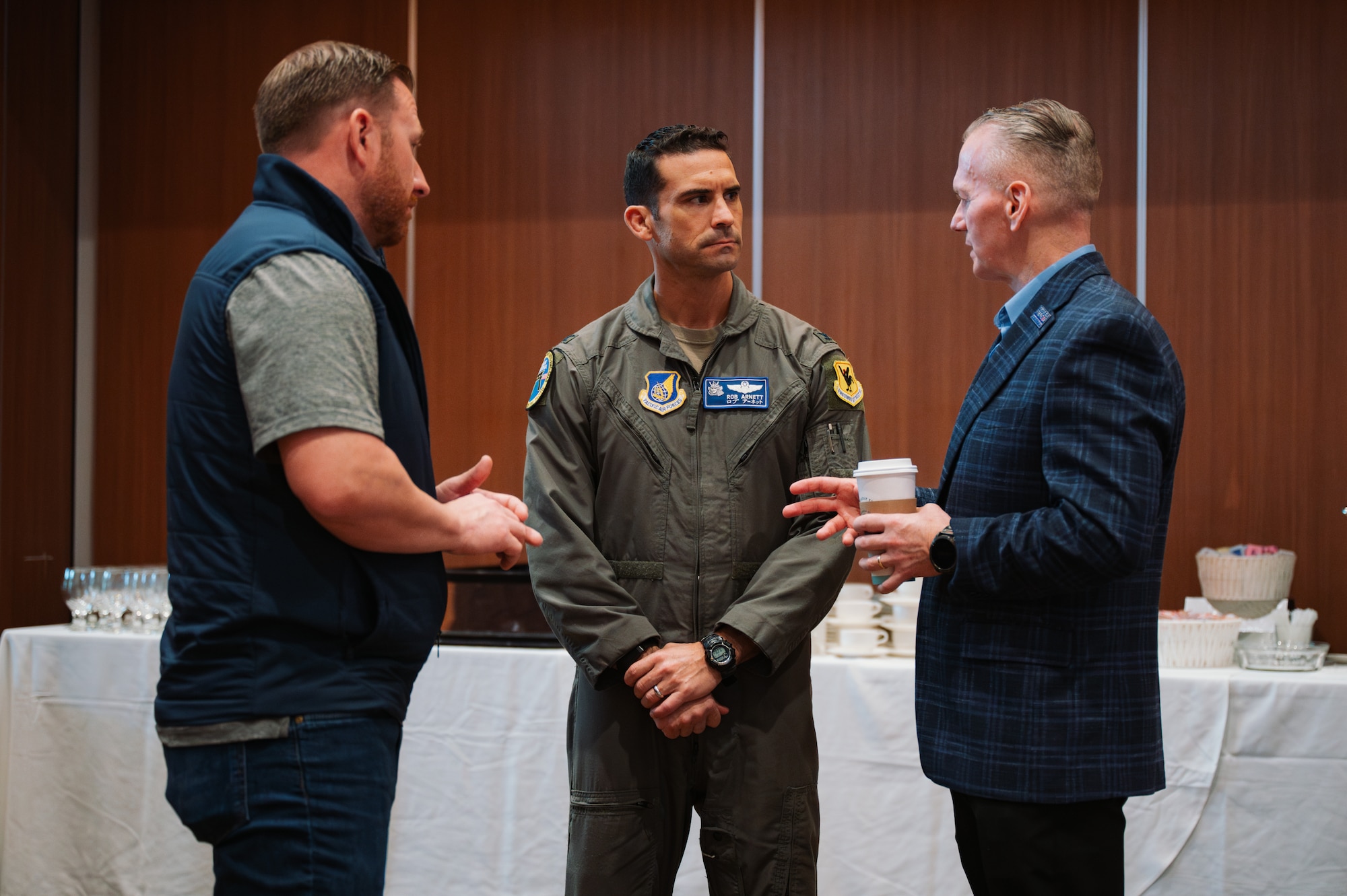 U.S. Air Force Col. Robert Arnett, center, 18th Wing deputy commander, speaks with Dan Smith, left, director of strategic engagements, and John Wayne Troxell, 3rd Senior Advisor to the Chairman of the Joint Chief of Staff, U.S. Army, during a career summit at Kadena Air Base, Japan, Feb. 5, 2026. The event connected attendees with a broad network of regional and national employers, creating opportunities for direct engagement, and long-term employment options. (U.S. Air Force photo by Airman 1st Class Francisco Huerta)