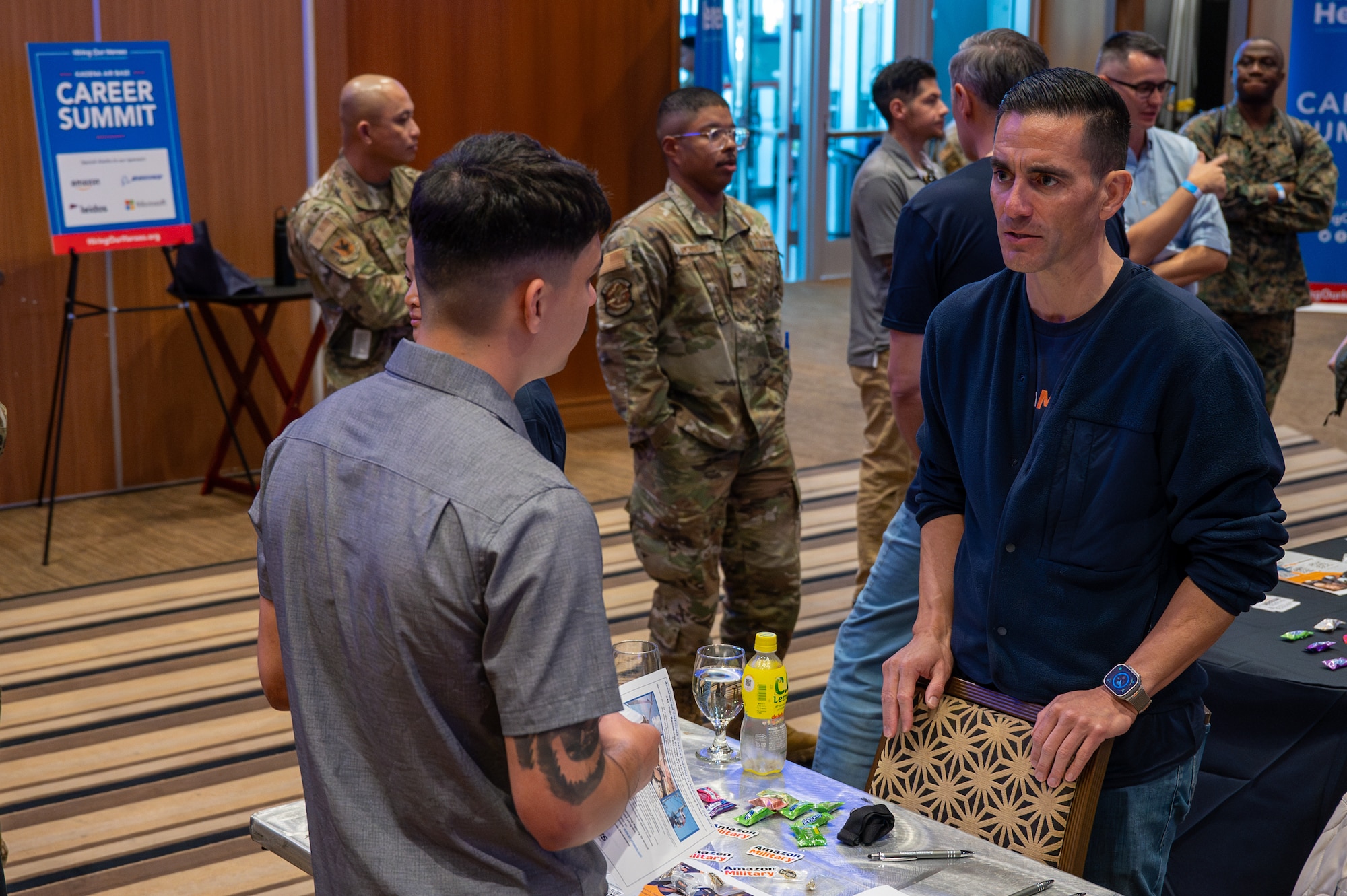 An attendee speaks with an employer during a career summit at Kadena Air Base, Japan, Feb. 5, 2026. The event connected attendees with regional and national employers, expanding access to career opportunities and professional networks. (U.S. Air Force photo by Airman 1st Class Francisco Huerta)