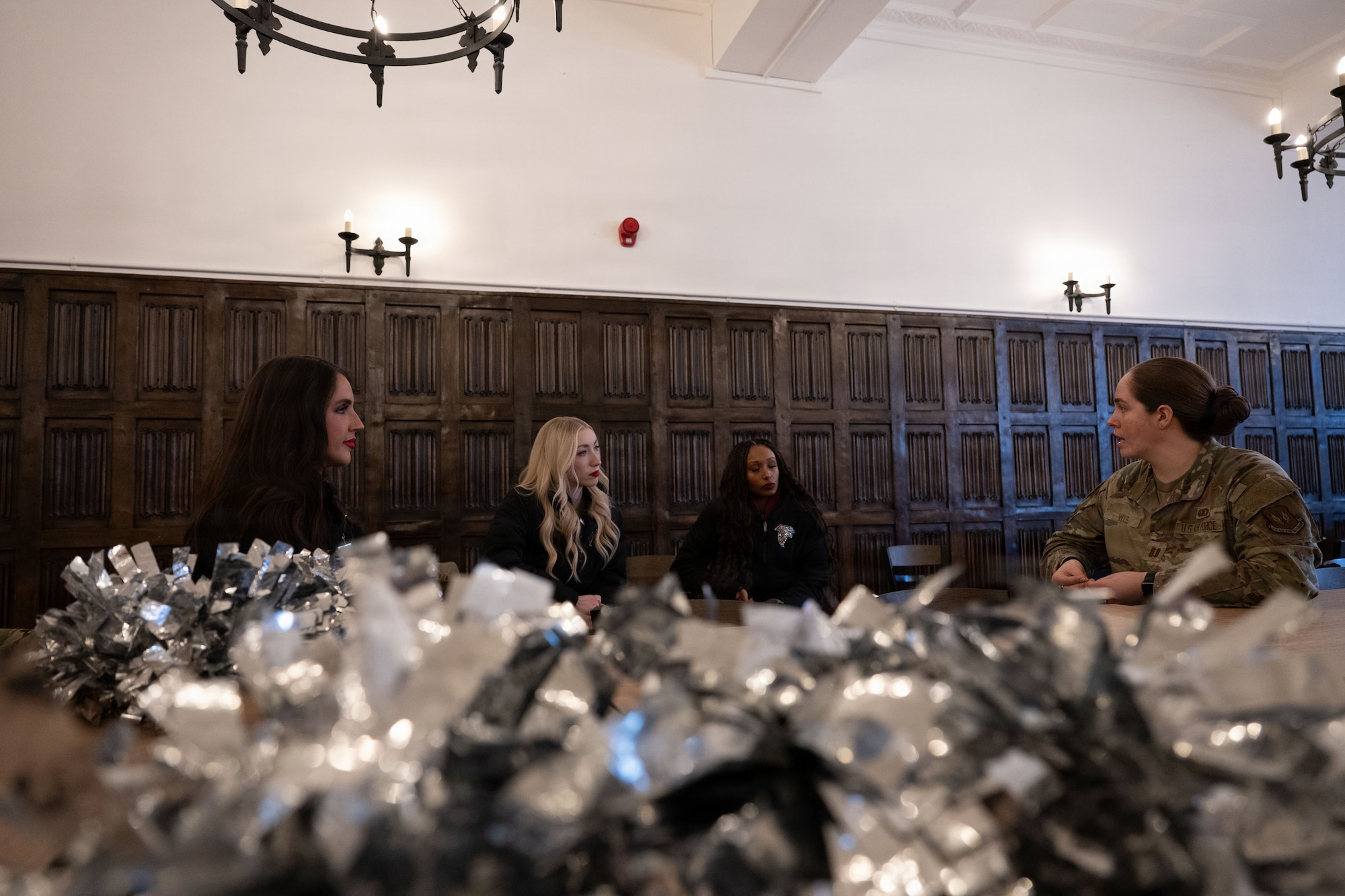 U.S. Air Force Capt. Emily Willis, right, 100th Force Support Squadron flight commander, talks to Atlanta Falcons cheerleaders during a Pro Blitz Armed Forces Entertainment tour at RAF Mildenhall, England, Jan. 30, 2026.
