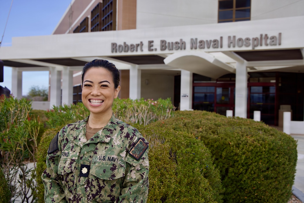 Cmdr. (select) Jasette Marian M. Fong, Pediatric Clinical Nurse Specialist and newly appointed Pediatric Advanced Life Support Program Director at Naval Hospital Twentynine Palms, poses for a photo in front of Robert E. Busch Memorial Hospital at Marine Corps Air Ground Combat Center, Twentynine Palms, Calif., Jan. 11, 2026. Fong brings more than 16 years of Navy experience to the role and will oversee the hospital’s Pediatric Advanced Life Support program to strengthen pediatric emergency readiness and training. (U.S. Navy photo by Christopher C. Jones, NHTP/NMRTC Twentynine Palms public affairs officer).