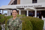Cmdr. (select) Jasette Marian M. Fong, Pediatric Clinical Nurse Specialist and newly appointed Pediatric Advanced Life Support Program Director at Naval Hospital Twentynine Palms, poses for a photo in front of Robert E. Busch Memorial Hospital at Marine Corps Air Ground Combat Center, Twentynine Palms, Calif., Jan. 11, 2026. Fong brings more than 16 years of Navy experience to the role and will oversee the hospital’s Pediatric Advanced Life Support program to strengthen pediatric emergency readiness and training. (U.S. Navy photo by Christopher C. Jones, NHTP/NMRTC Twentynine Palms public affairs officer).