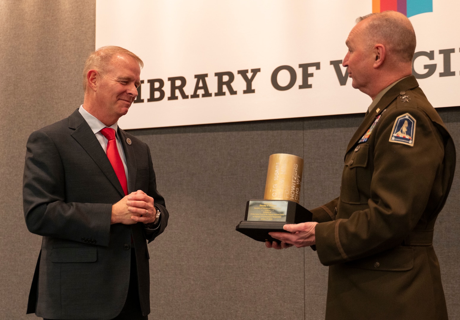 Maj. Gen. Ring presents a shell casing to Sec. Williams