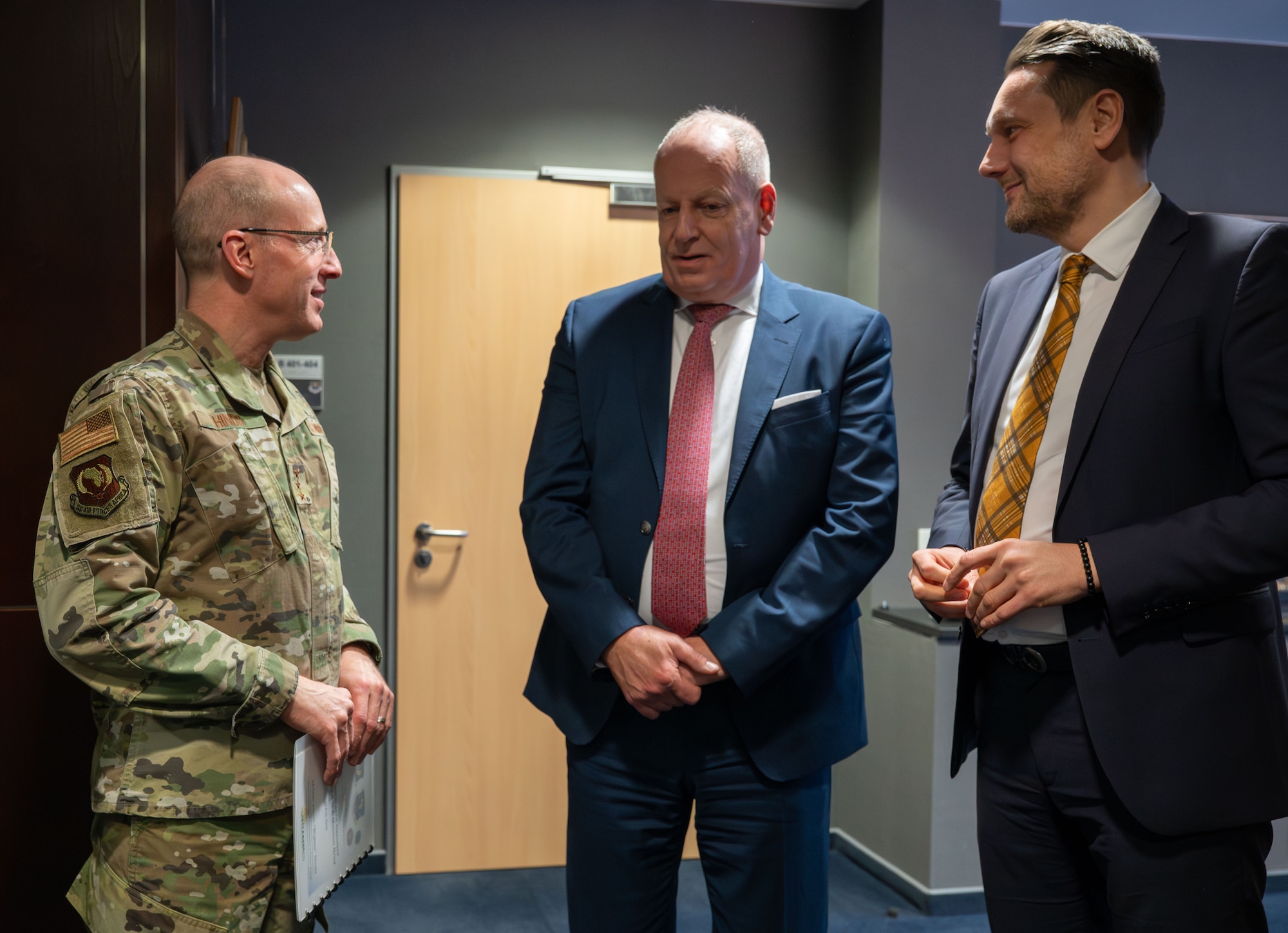 U.S. Air Force Lt. Gen. Jason T. Hinds (left), U.S. Air Forces in Europe – Air Forces Africa commander, greets Ambassador Jens Hanefeld (center), German Ambassador to the United States, and State Secretary Daniel Stich (right), Rheinland-Pfalz Ministry of the Interior