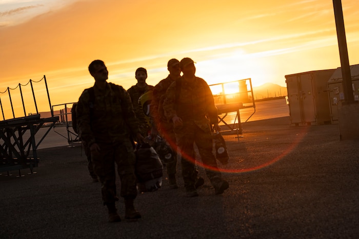 U.S. Air Force Airmen assigned to the 55th Rescue Squadron walk towards friends and family after a redeployment at Davis-Monthan Air Force Base, Arizona, Feb. 6, 2026. The redeployment marked the conclusion of a months-long deployment in the Middle East. (U.S. Air Force photo by Airman 1st Class Samantha Melecio)