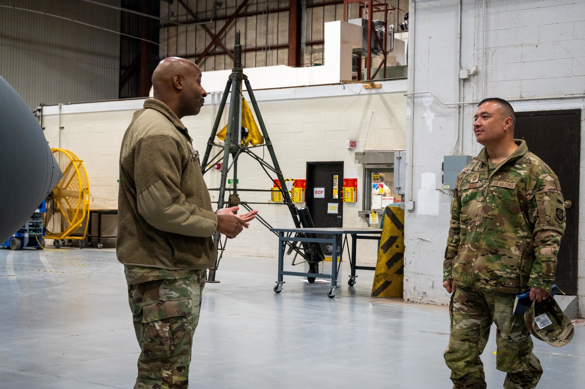 U.S. Air Force Master Sgt. Clifford Coleman, 317th Maintenance Squadron maintenance flight chief, briefs Chief Master Sgt. Joseph Arce, Eighteenth Air Force command chief, on C-130J Super Hercules external fuel tank capabilities during a visit to Dyess Air Force Base, Texas, Jan. 30, 2026. The capability extends the 317th Airlift Wing’s range and endurance, enabling maximum endurance operations and increased operational reach in contested environments. (U.S. Air Force photo by Airman William Neal)