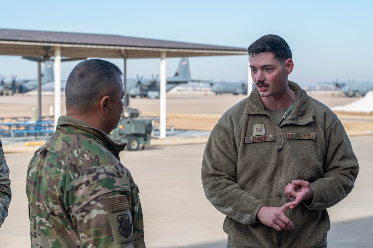 U.S. Air Force Tech. Sgt. Blake Livigni, 317th Maintenance Group tactics section chief, briefs Chief Master Sgt. Joseph Arce, Eighteenth Air Force command chief, on the Rapid Expeditionary Kit during a tour at Dyess Air Force Base, Texas, Jan. 30, 2026. The REX Kit is a self-contained communications and mission-support package that provides secure voice, data and networking tools enabling rapid command and control in dispersed, contested environments. (U.S. Air Force photo by Airman William Neal)