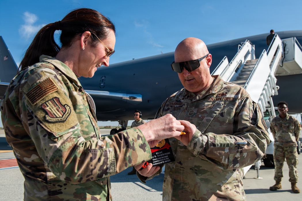 Chief presents plaque to another chief.