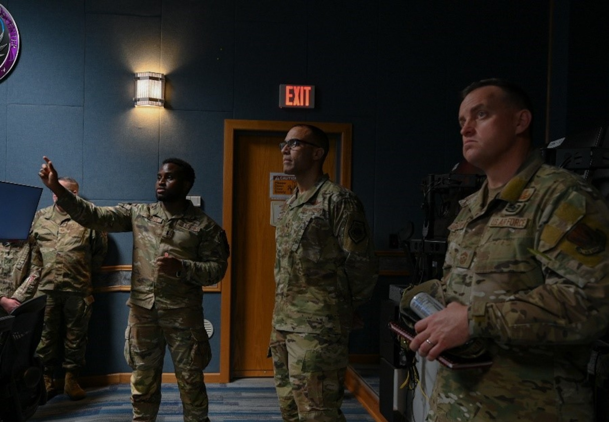 A lieutenant briefs functions of the joint mission operations center to ACC commander.