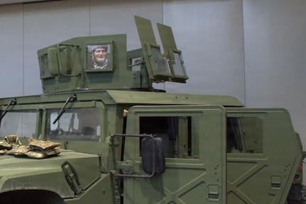 Franklin George stands in the gunner’s turret of an M1151A1 at the Chicago Auto Show in Chicago on Feb. 11, 2026.