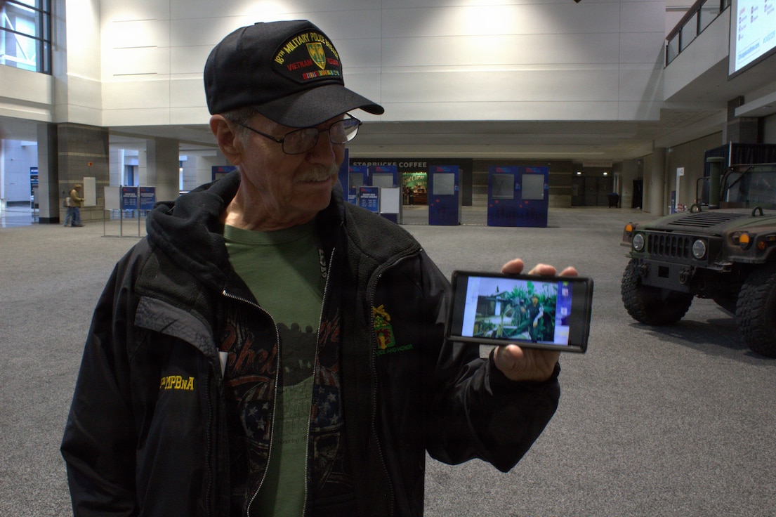 Terry Abma shares his history in the 504th Military Police Battalion with members of the Illinois National Guard at the Chicago Auto Show in Chicago.