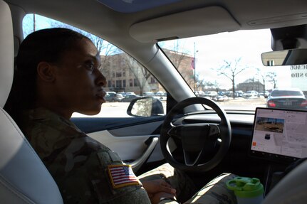 1st Lt. Lake Mitchelle tries the full self-driving feature on a Tesla Model Y at the Chicago Auto show in Chicago.