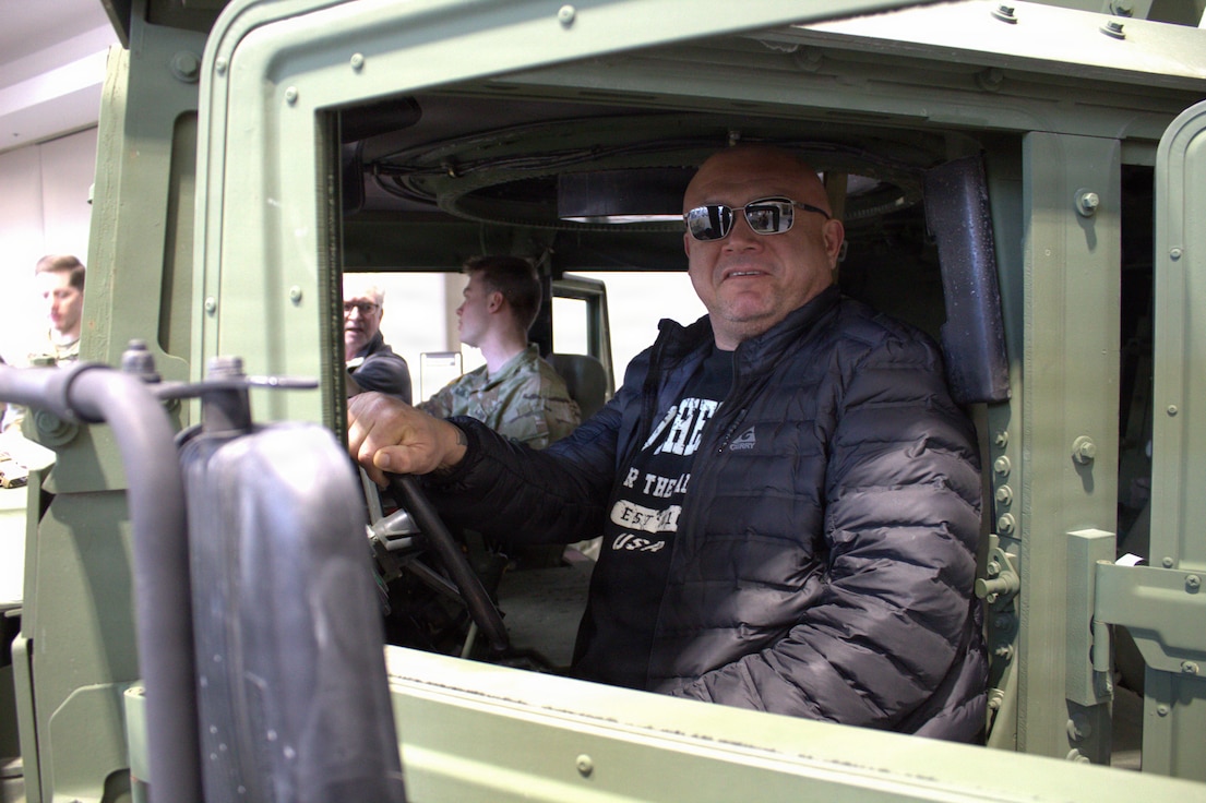 Sal Reyes, a local business owner, sits in the driver seat of an M1151A1 at the Chicago Auto Show in Chicago.