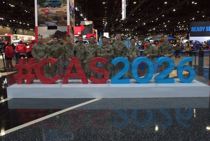Soldiers of the Illinois Army National Guard pose in front of the entrance to the main exhibit hall of the Chicago Auto Show.