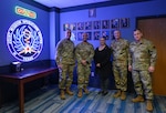 From left: U.S. Air Force Gen. Adrian Spain, commander of Air Combat Command, Lt. Col. Oscar Nunez, Jr., 367th Cyberspace Operations Squadron commander, Ms. Elizabeth Hachtel, 367th COS, Joint Mission Operations Center – Texas Deputy Director, Master Sgt. Richard Chandler, 367th COS Senior Enlisted Leader, and Chief Master Sgt. Jeremy Untersheher, ACC command chief, stand in front of the Joint Mission Operations Center neon sign at Joint Base San Antonio-Lackland, Texas, Feb. 4, 2026. The lighting of the JMOC neon sign signals that 67th Cyberspace Wing Airmen are on mission within the facility. (U.S. Air Force photo by Jantzen Floate)