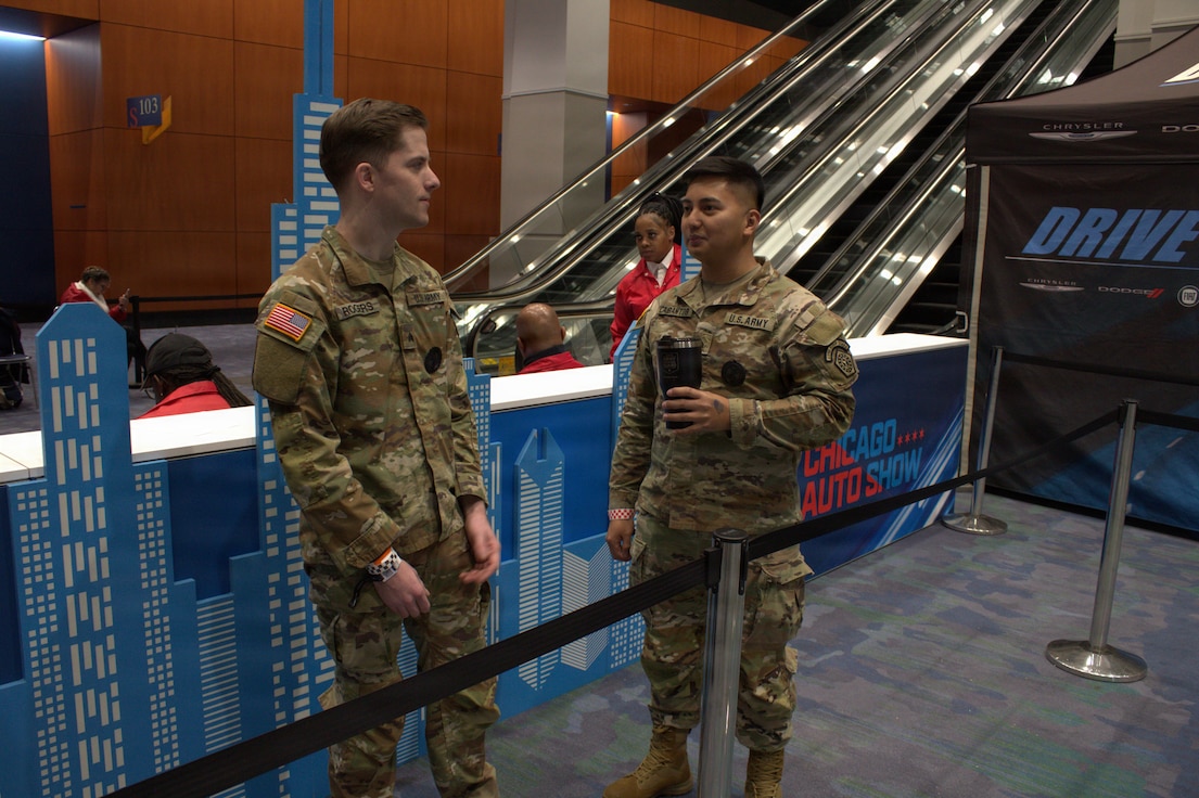 Recruiters with Bravo Company Illinois National Guard Recruiting and Retention Command, wait in line for their chance to test drive a vehicle at the Chicago Auto Show in Chicago.